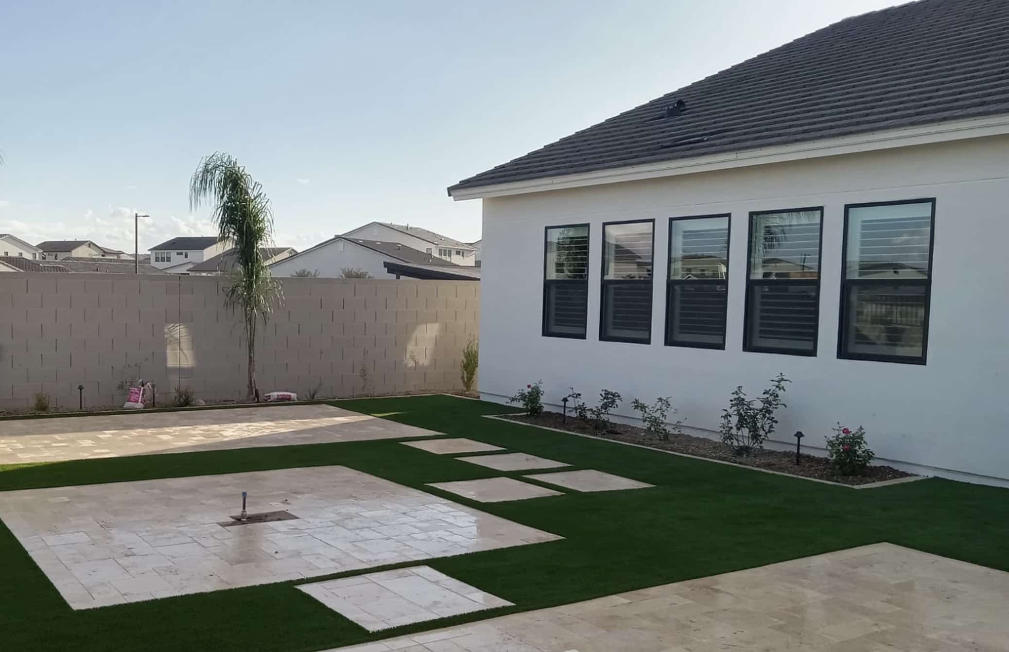 A modern Arizona garden design incorporating drought-resistant plants, innovative lighting solutions, and sustainable materials